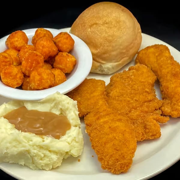 Myra Jean's fried chicken tenders, mashed potatoes with gravy, tater tots, and a dinner roll.