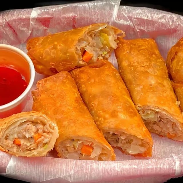 Flavorful Pork Egg Rolls with Sweet & Sour Sauce.